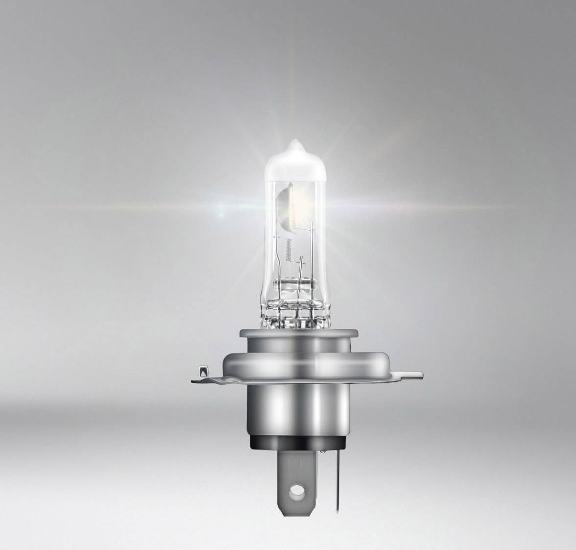 Una luminosa lampada alogena su uno sfondo grigio, che mostra la sua struttura in vetro e la base metallica.