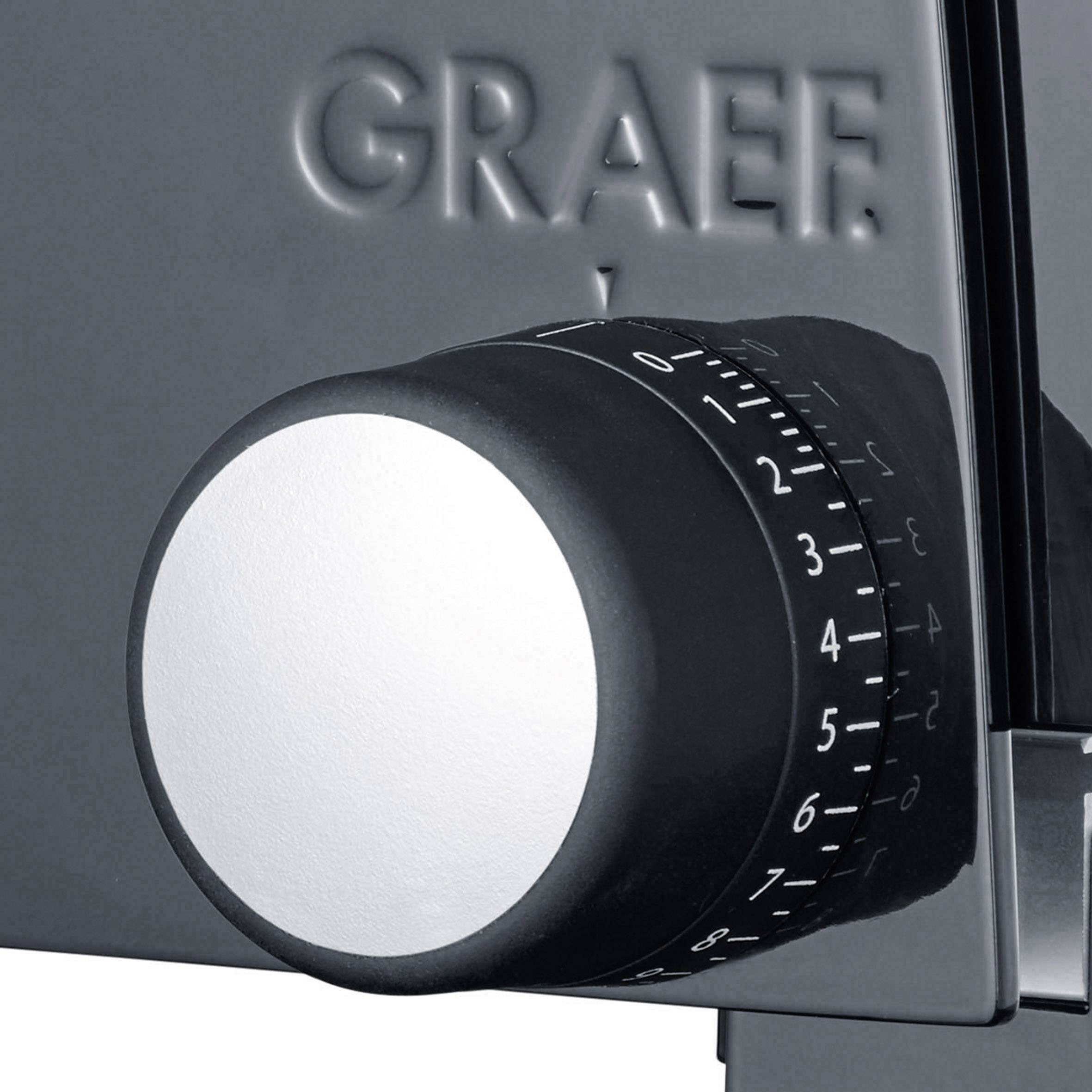 Un regolatore grigio con numeri da 0 a 15, montato su un elettrodomestico da cucina, presumibilmente per regolare lo spessore del taglio.