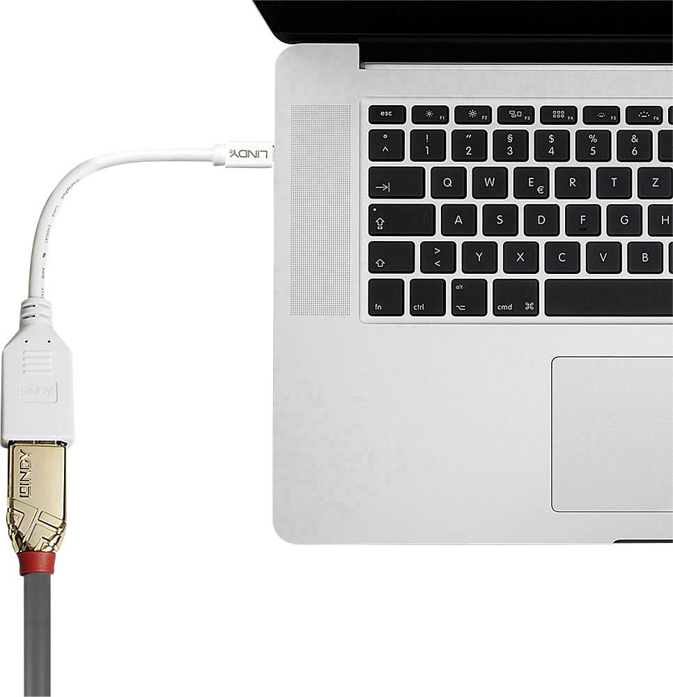 Un cavo è collegato a un laptop che connette un dispositivo periferico. Tastiera e touchpad sono visibili.