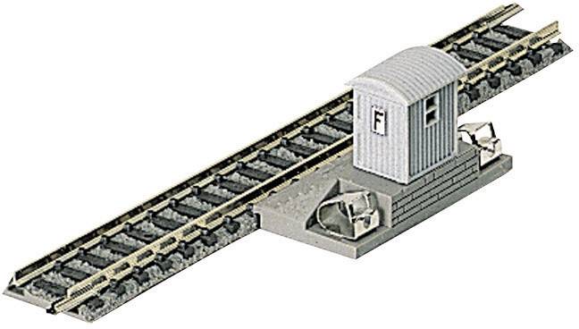 Un modello di binario ferroviario con una piccola capanna all'incrocio. Il binario ha scambi a forma di L con una piattaforma.