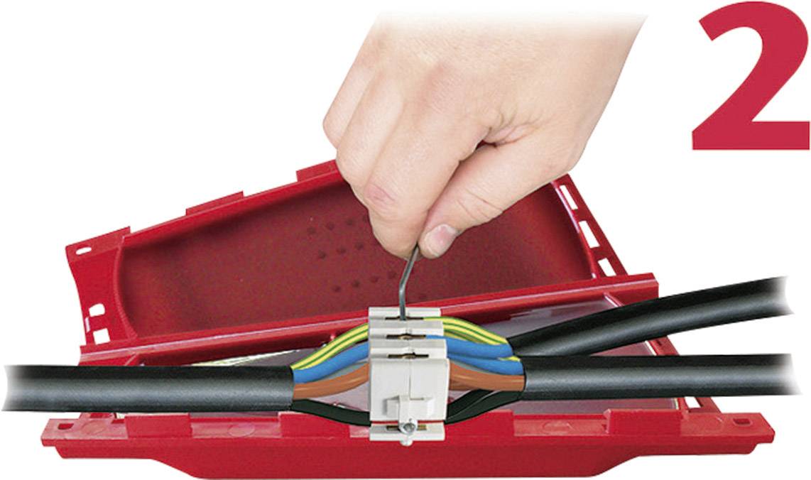 Una mano collega fili colorati in un morsetto di connessione rosso. Il numero '2' è posizionato in alto a destra.