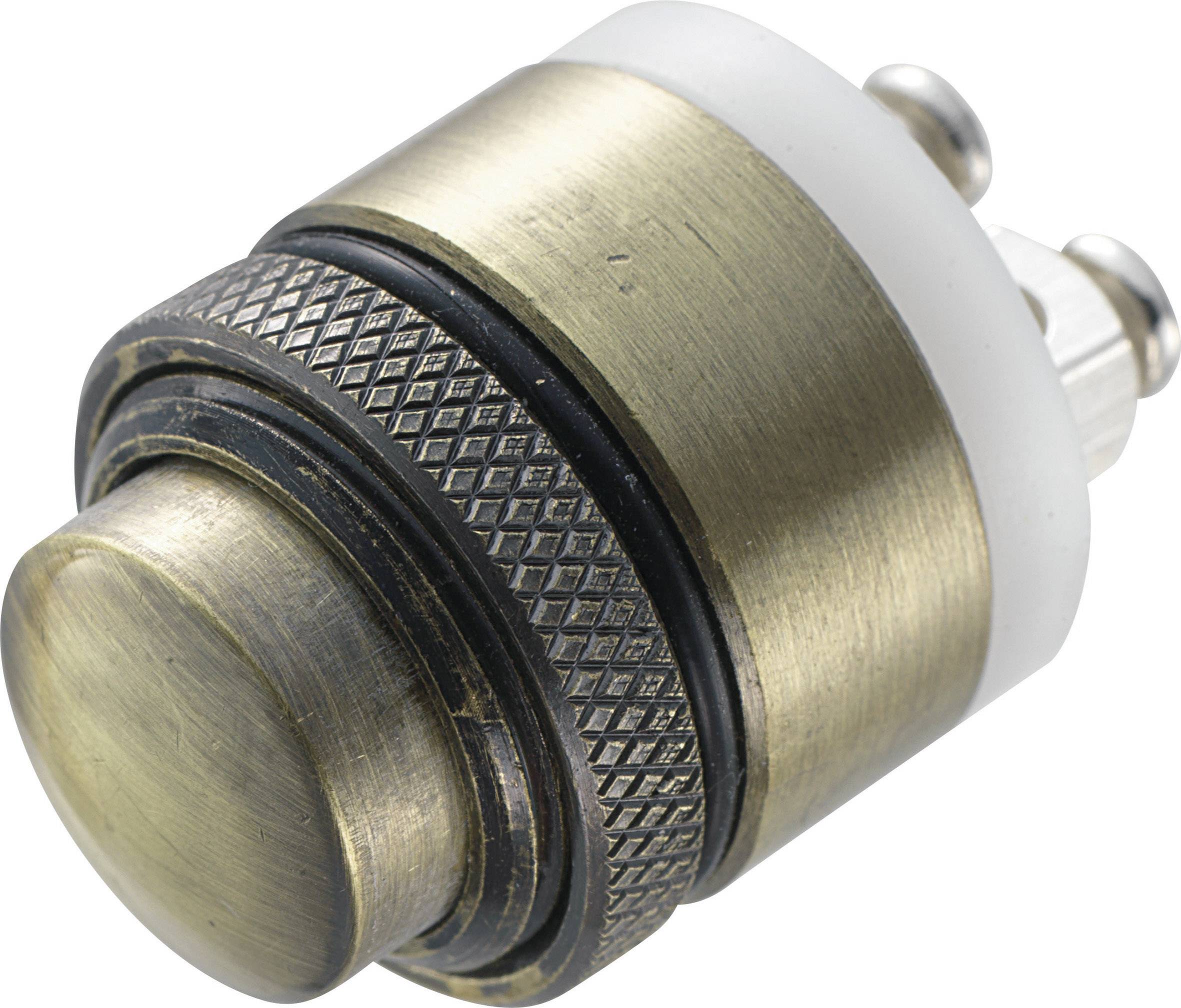 Un pulsante rotondo, metallico, con un motivo zigrinato, circondato da un anello bianco, probabilmente parte di un dispositivo elettrico.
