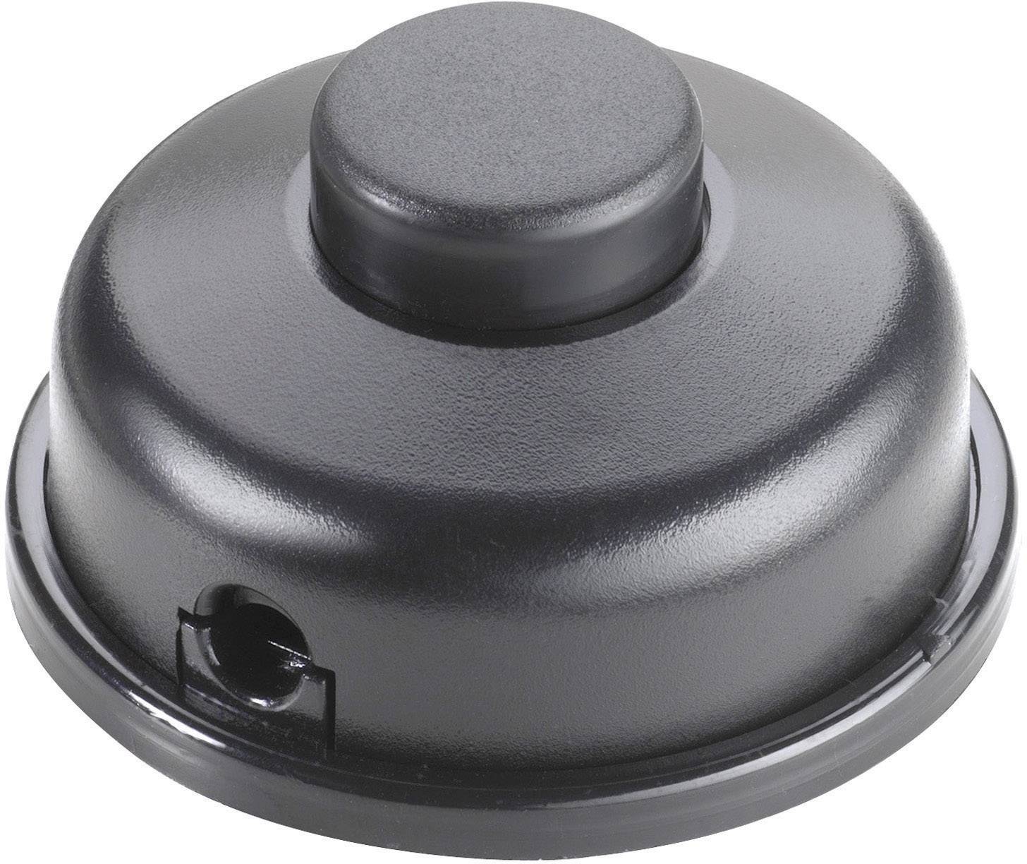 Un coperchio nero, rotondo, con un dischetto più piccolo e rialzato al centro e un'apertura sul lato.