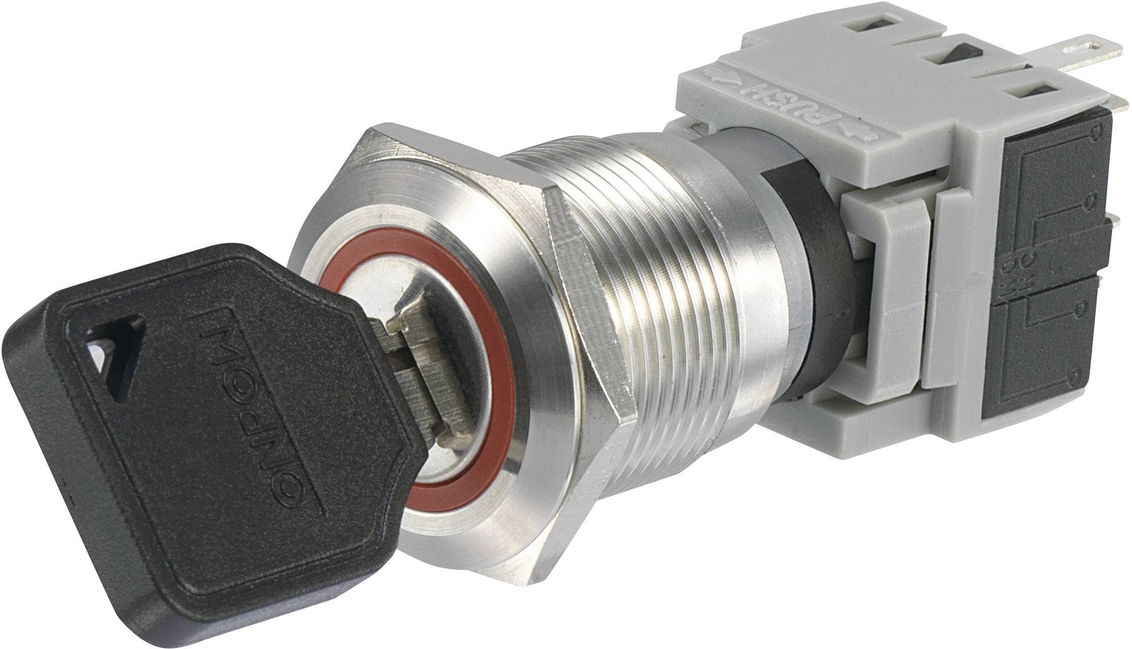 Un interruttore di sicurezza in metallo con chiave. La chiave è inserita nella serratura, che è circondata da una parte in plastica grigia.