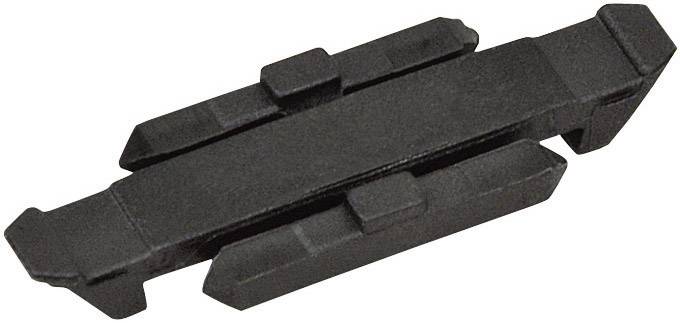 Un componente nero e rettangolare in plastica con diverse sporgenze e rientranze, probabilmente un elemento di giunzione o distanziale.