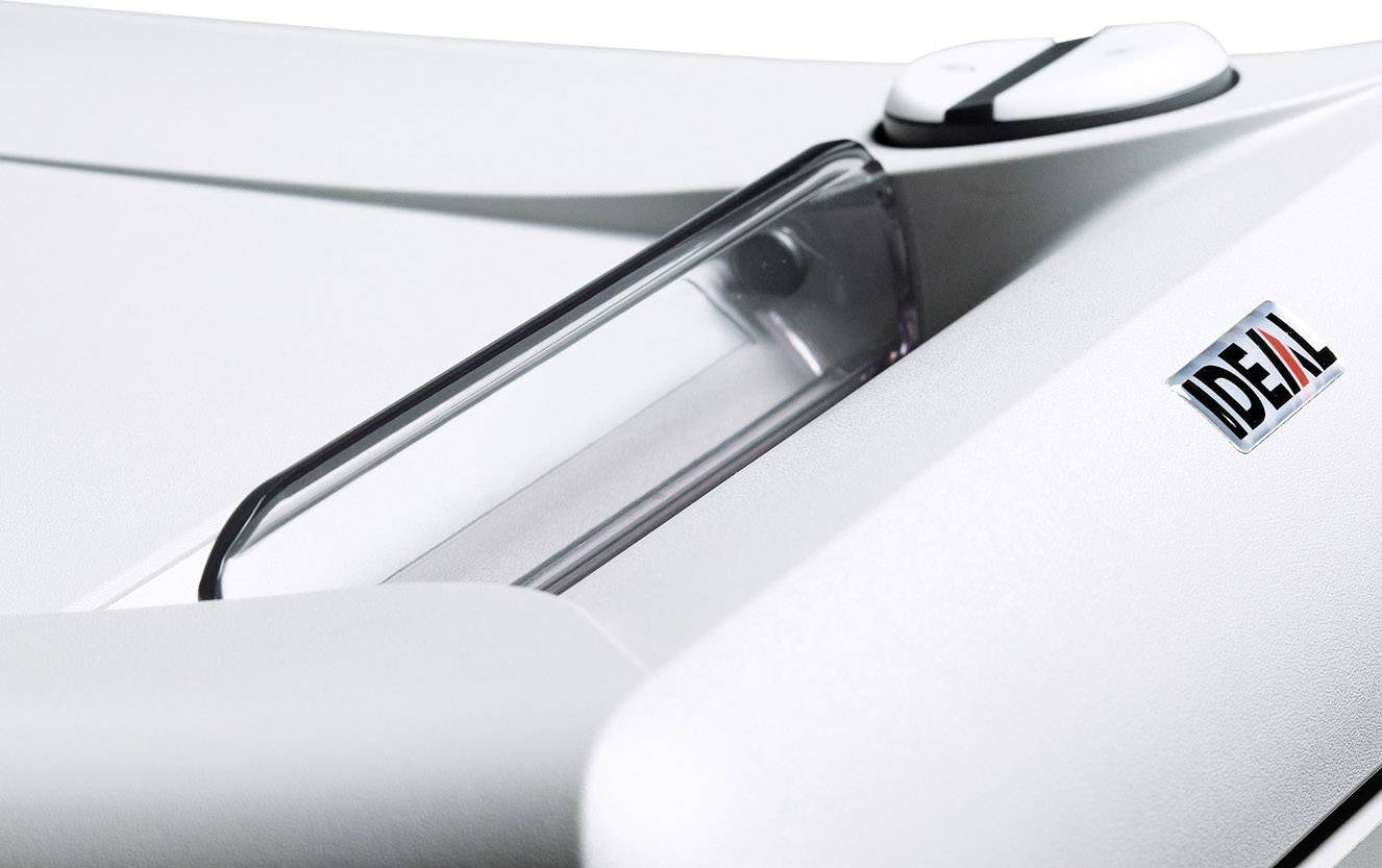 Un dispositivo per ufficio con una sezione del corpo trasparente e un logo del marchio 'IDEAL' su una superficie bianca.