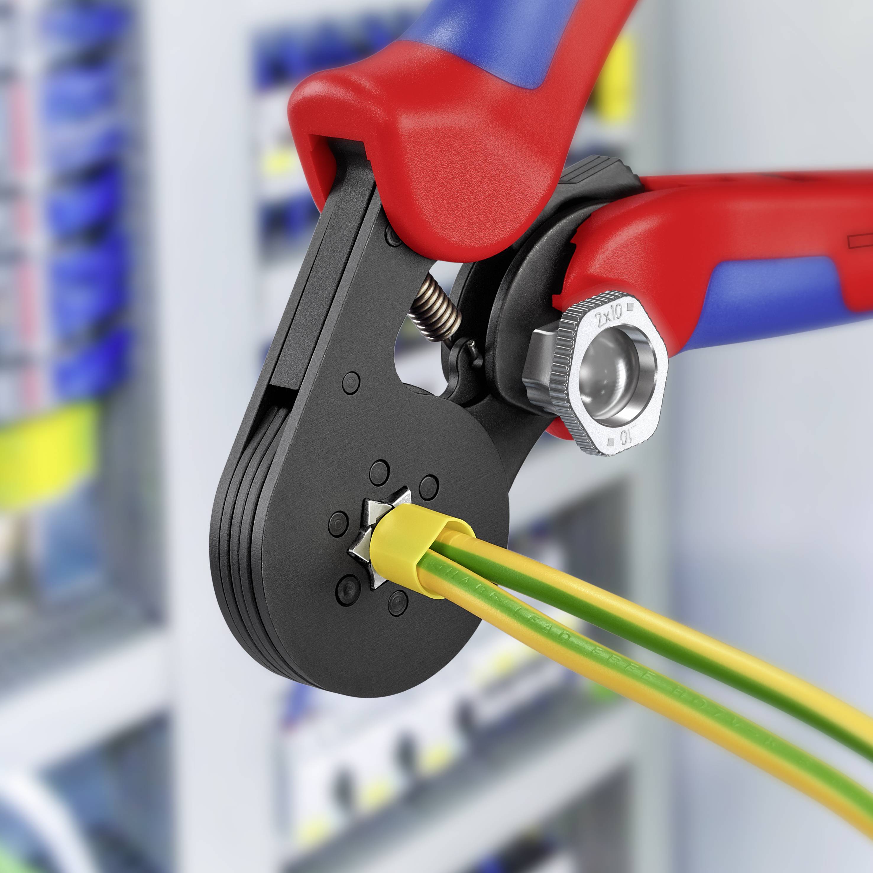 Een krimptang perst kabelklemmen op geïsoleerde draden. Op de achtergrond een elektrische schakelkast-setup.