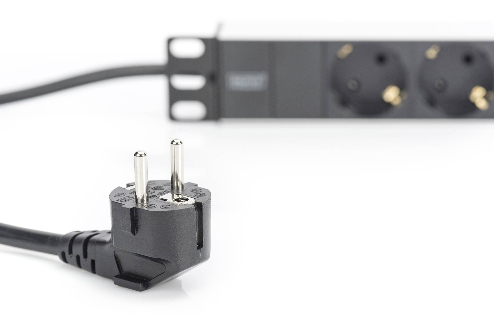 Een zwarte Europlug ligt voor een stekkerdoos.