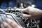 Een close-up van een hand die met een moersleutel een bout vastdraait op een mechanische motor, omringd door verschillende buizen en draden.