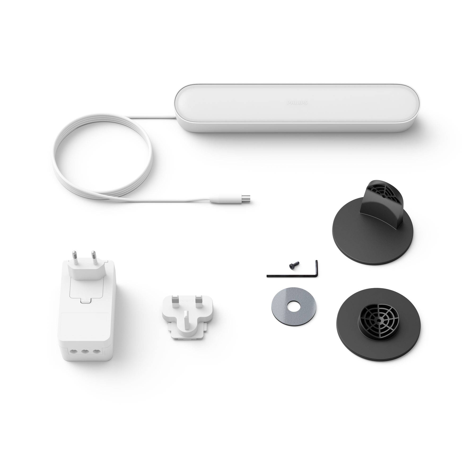 Een witte Hue Bridge met stroomkabel en adapter, vergezeld van montagemateriaal op een witte achtergrond.