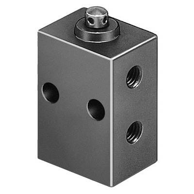 Een rechthoekige metalen blok met vier boringen en een cilindrische knop bovenop, waarschijnlijk een technisch onderdeel.
