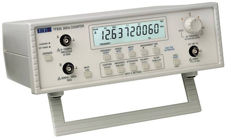 Digitaal frequentiemeetapparaat met display toont '12.637720060'. Toetsen en knoppen voor frequentiemeting zijn zichtbaar. Apparaat staat op standaard.
