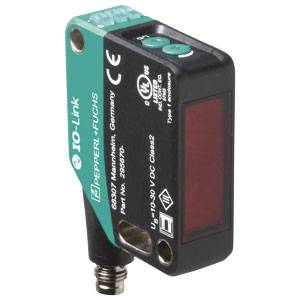 Een rechthoekige, zwart-groene IO-Link-sensor van Pepperl+Fuchs met een rood zichtvenster en twee knoppen aan de bovenkant.