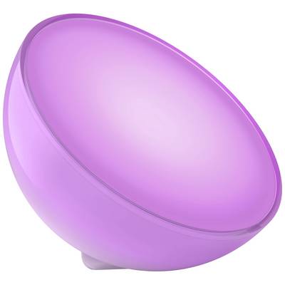Een paarse lichtbol staat op een tafel, schijnt zacht in een donkere ruimte en zorgt voor een sfeervolle atmosfeer.