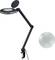 Een zwarte bureaulamp met verstelbare arm en loep, naast een losse lens. Ideaal voor gedetailleerd werk.