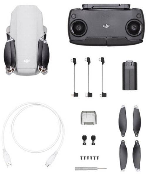 DJI Drone-set bestaande uit drone, afstandsbediening, accu, reservepropellers, oplaadkabels en schroevendraaier op witte achtergrond.