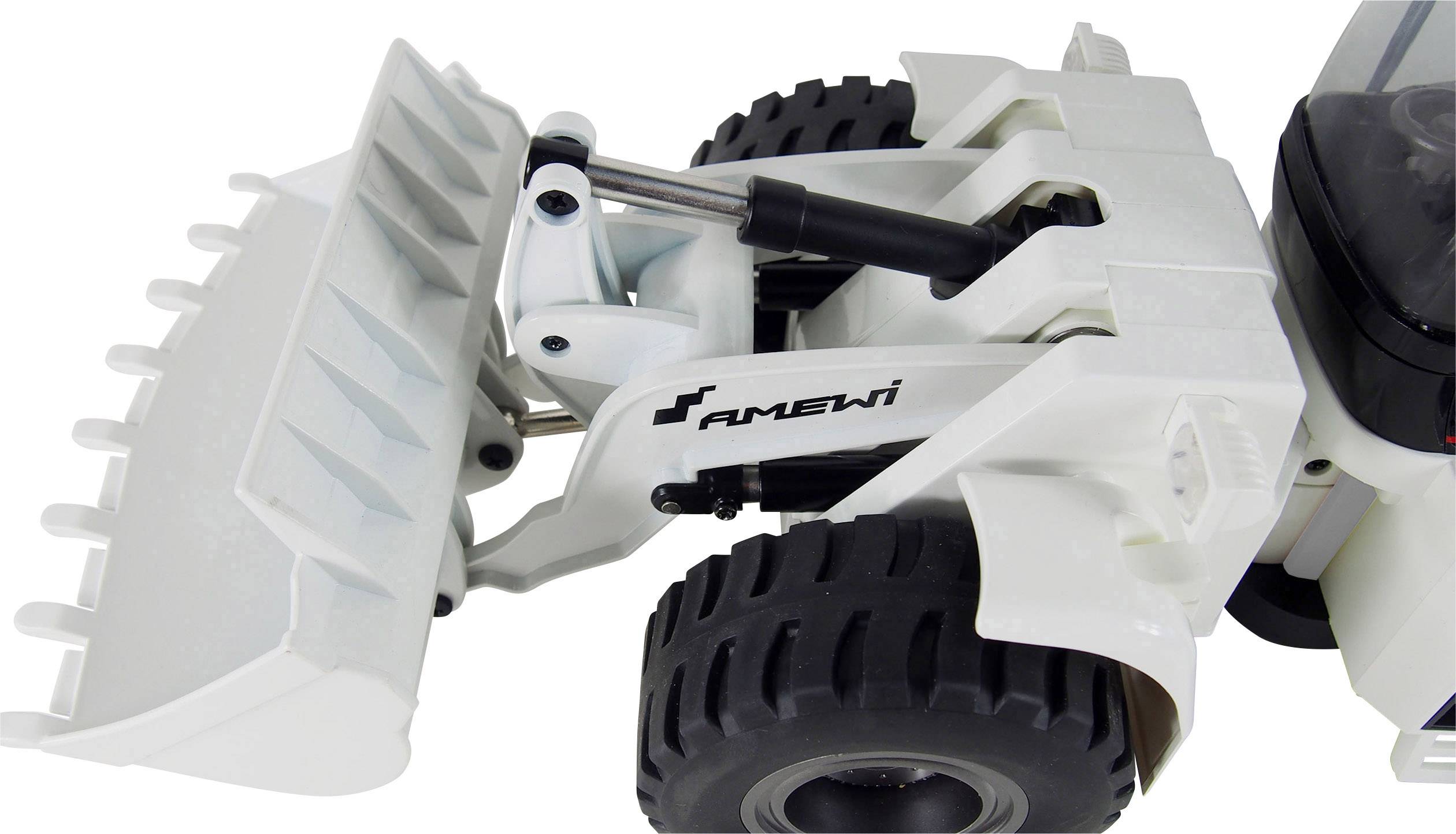 Een witte speelgoed-graafmachine met zwarte opdruk en grote wielen is te zien. De schep is opgetild.