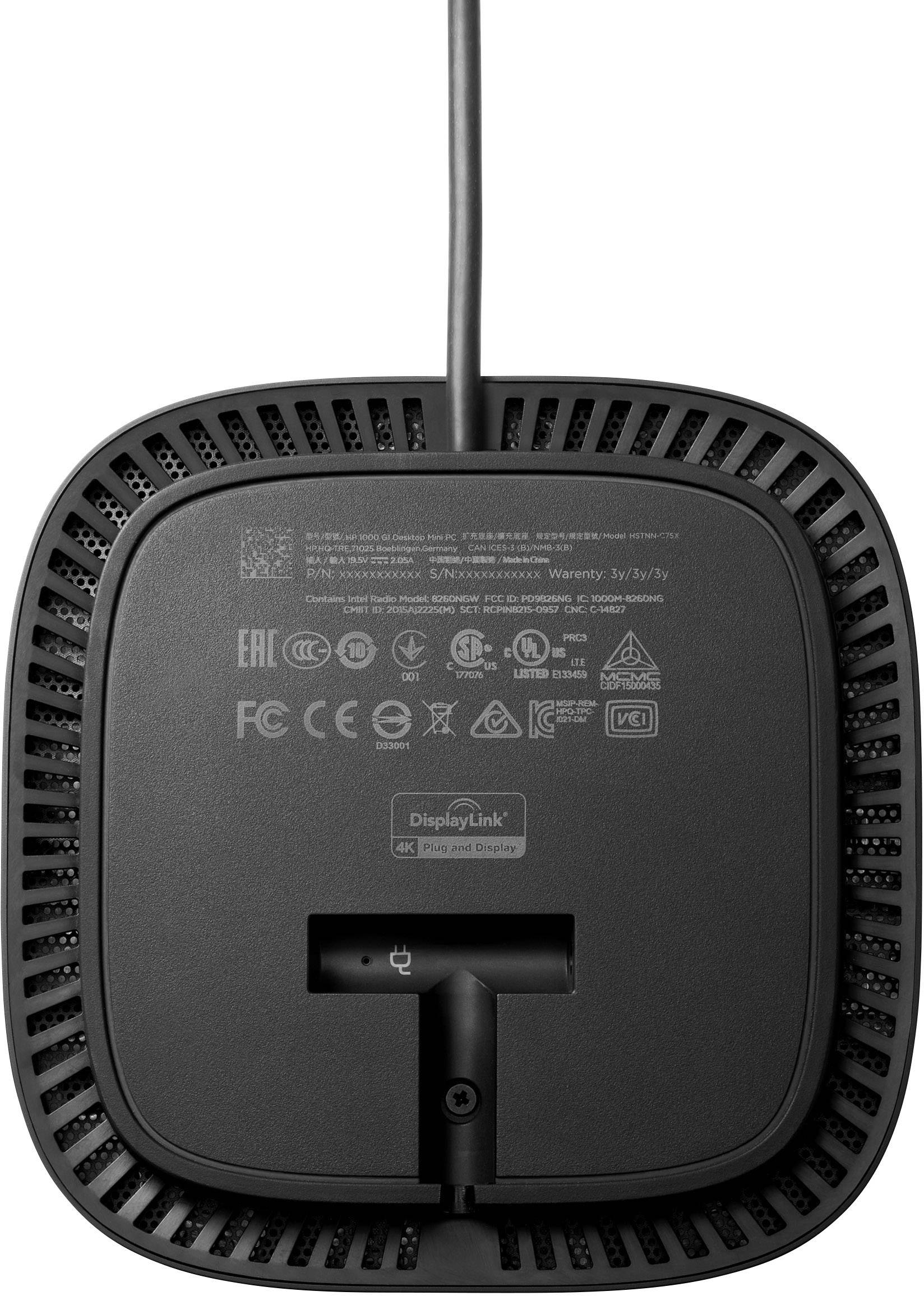 'Achterkant van een elektronische doos met verschillende zegels en een kabel. Toont merk- en veiligheidscertificeringen.'