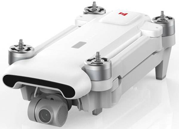 Een witte drone met camera, ingeklapt. Zichtbaar zijn vier rotors en de cameralens aan de voorkant.