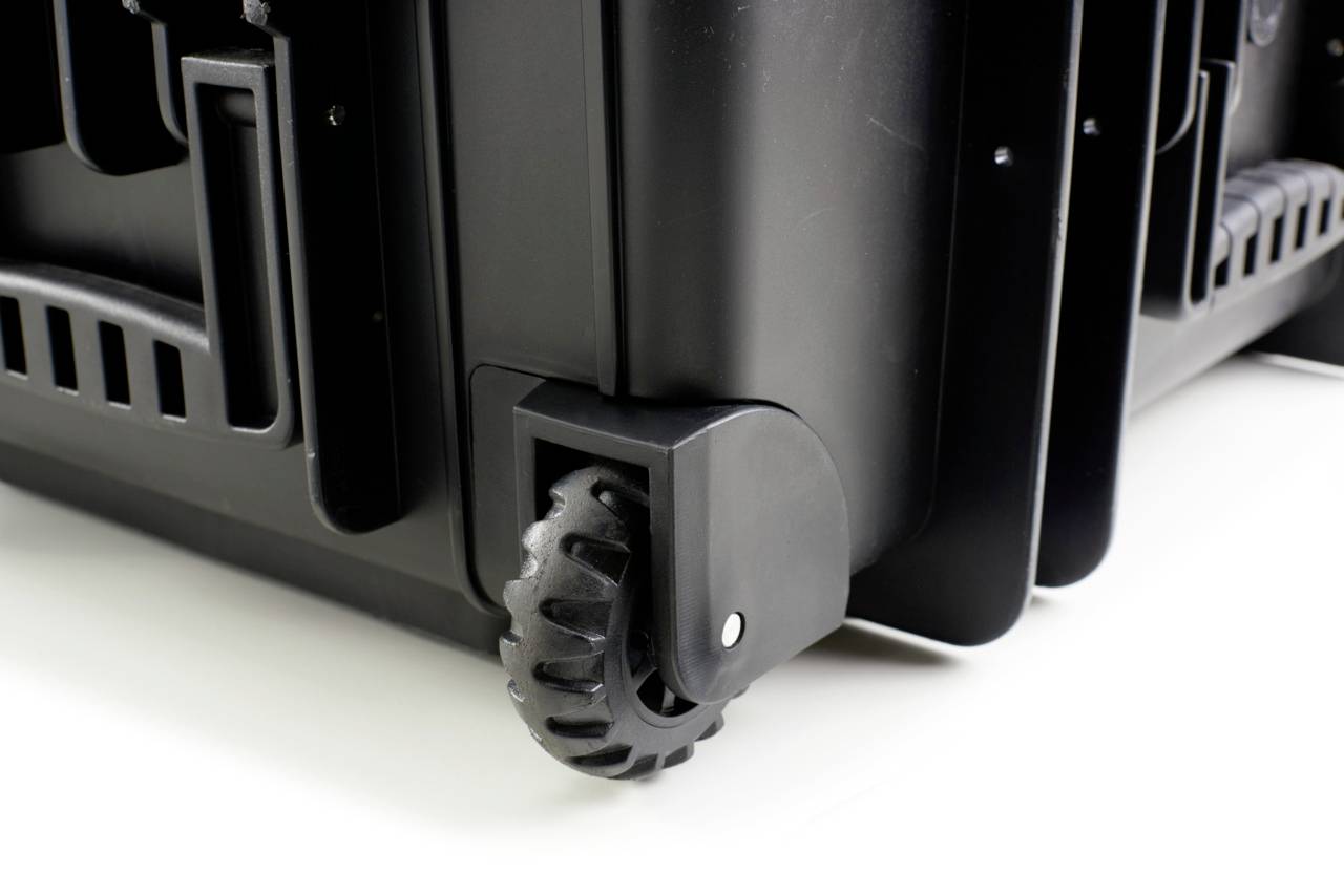 Close-up van een zwarte trolley met stevige wielen.