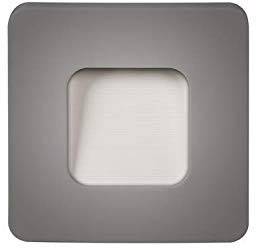 Vierkante lichtschakelaar met een donker frame en een lichte, vierkante drukknop in het midden. Modern design, minimalistische uitstraling.
