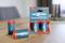 Four blue Ansmann alkaline batteries, Type D, on a table; two standing in original packaging, two lying loose.