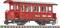Rood model van een historische spoorwagen van de Zillertalbahn met het opschrift 'Gemeente Uderns', staand op rails.