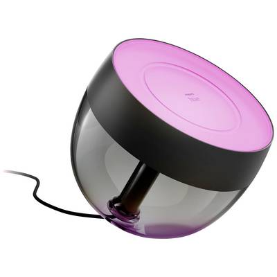 Een zwarte, halfbolvormige tafellamp met een transparant onderste gedeelte, bovenaan voorzien van een roze oplichtende kap, aangesloten op een kabel.