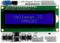 Een LCD-display toont de tekstregels 'Velleman IO' en 'VMA203'. Daaronder bevinden zich verschillende knoppen en aansluitingen op een shield.