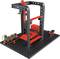 Een 3D-printer-set toont een frame met rode en zwarte onderdelen op een geperforeerde plaat, klaar voor assemblage.