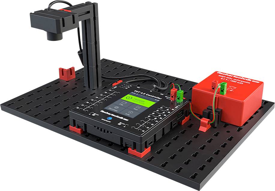 Experimentopstelling met sensorarm, elektronica-eenheid en rode voeding op een modulair kunststofbord voor wetenschappelijke tests.