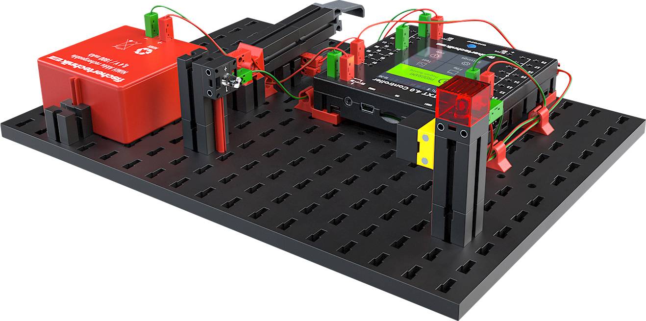 Een elektronicabouwpakket op een zwarte basisplaat. Het bevat een rode accu, draden en elektronische modules voor stroommetingen.