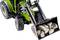 Een groene tractor met een voorlader tilt een schep vol stenen op.