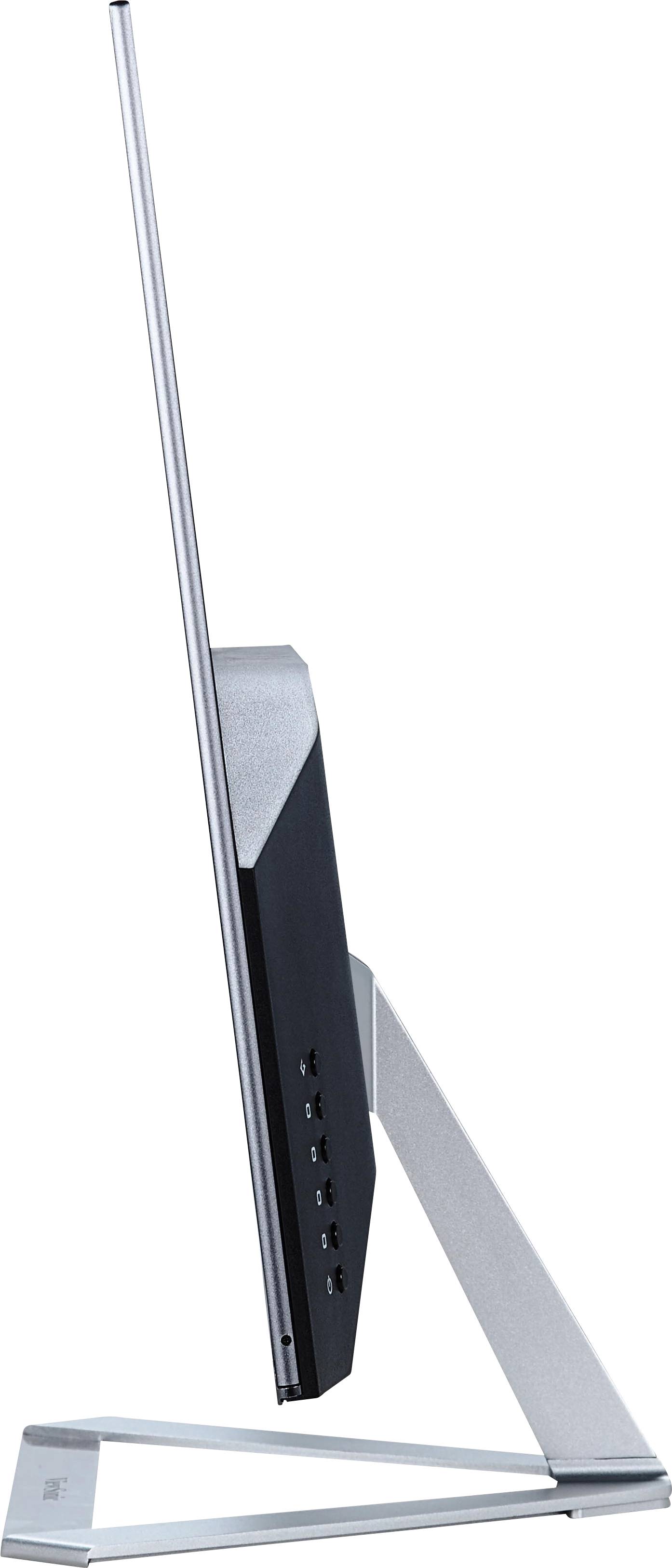 Een ultraplatte monitor van opzij gezien, met een slanke metalen standaard en meerdere aansluitingen aan de zijkant.