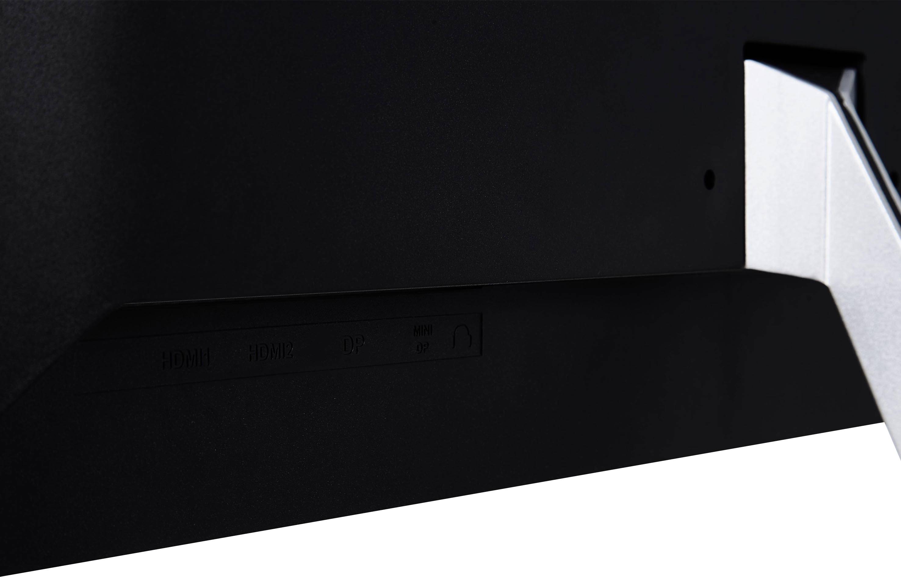 Achteraanzicht van een zwarte monitor, gericht op de zilveren standaard die zich uitstrekt vanuit de rechterrand.