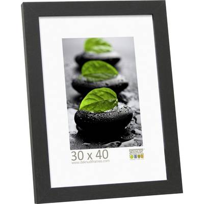 Een fotolijst met een zwarte rand toont een afbeelding van stenen waarop groene bladeren liggen. Afmetingen van de lijst: 30 x 40 cm.