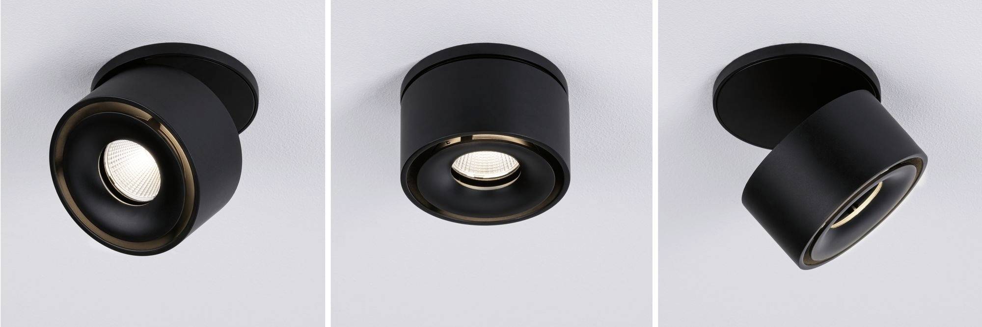 Drie zwarte plafondlampen met een cilindrisch ontwerp, gemonteerd aan een witte plafond; één is gefixeerd, de andere zijn draaibaar.