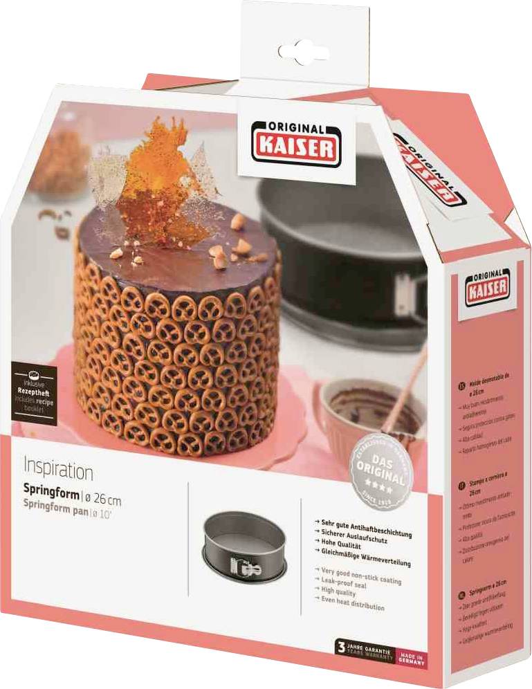 Verpakking van een springvorm van 'Original Kaiser', 26 cm. Een afbeelding toont een gedecoreerde taart. Tekst beschrijft productkenmerken.
