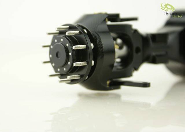 Close-upfoto van een zwart mechanisch onderdeel met meerdere zilveren pinnen, waarschijnlijk deel van een groter technisch apparaat.
