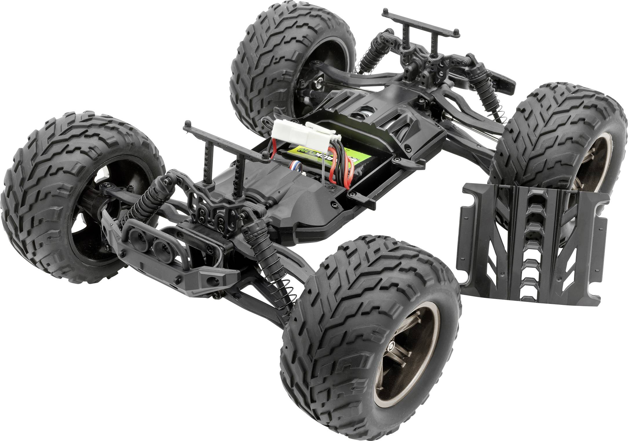 Een op afstand bestuurde auto-chassis zonder carrosserie, met grote terreinbanden en een zichtbaar accuvak, op een witte ondergrond.