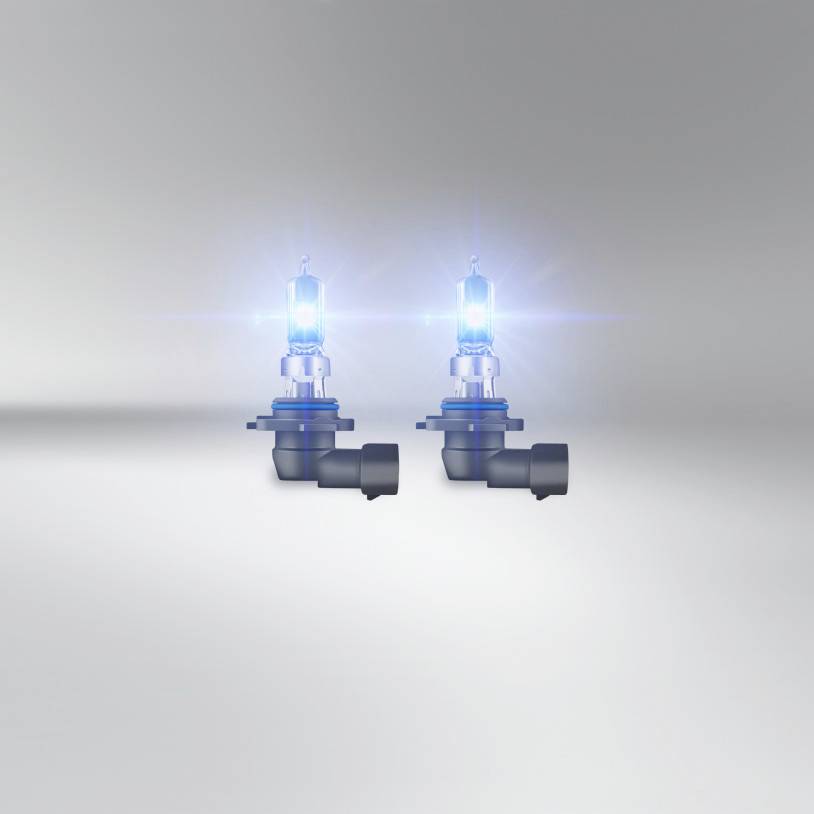 Twee halogeenlampen schijnen op een grijze achtergrond. Ze zijn naast elkaar geplaatst en stralen blauwachtig licht uit.