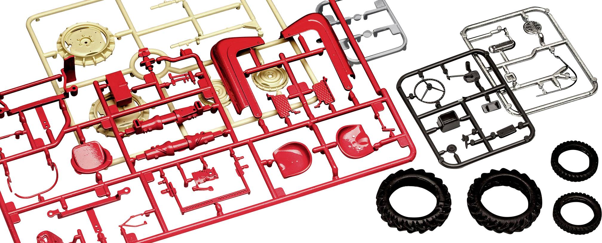 Bouwpakket met rode, gouden en zwarte kunststonderdelen en banden, klaar voor de assemblage van een modelvoertuig.
