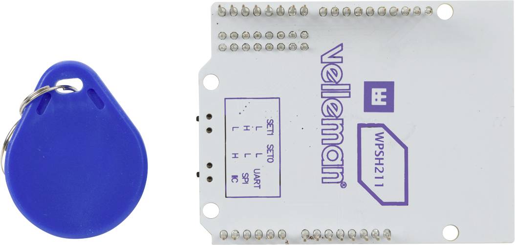 Elektronische module met blauwe RFID-tag links. Markeringen: 'velleman', 'WPSH211'. Bevat pinnen en knop op printplaat.