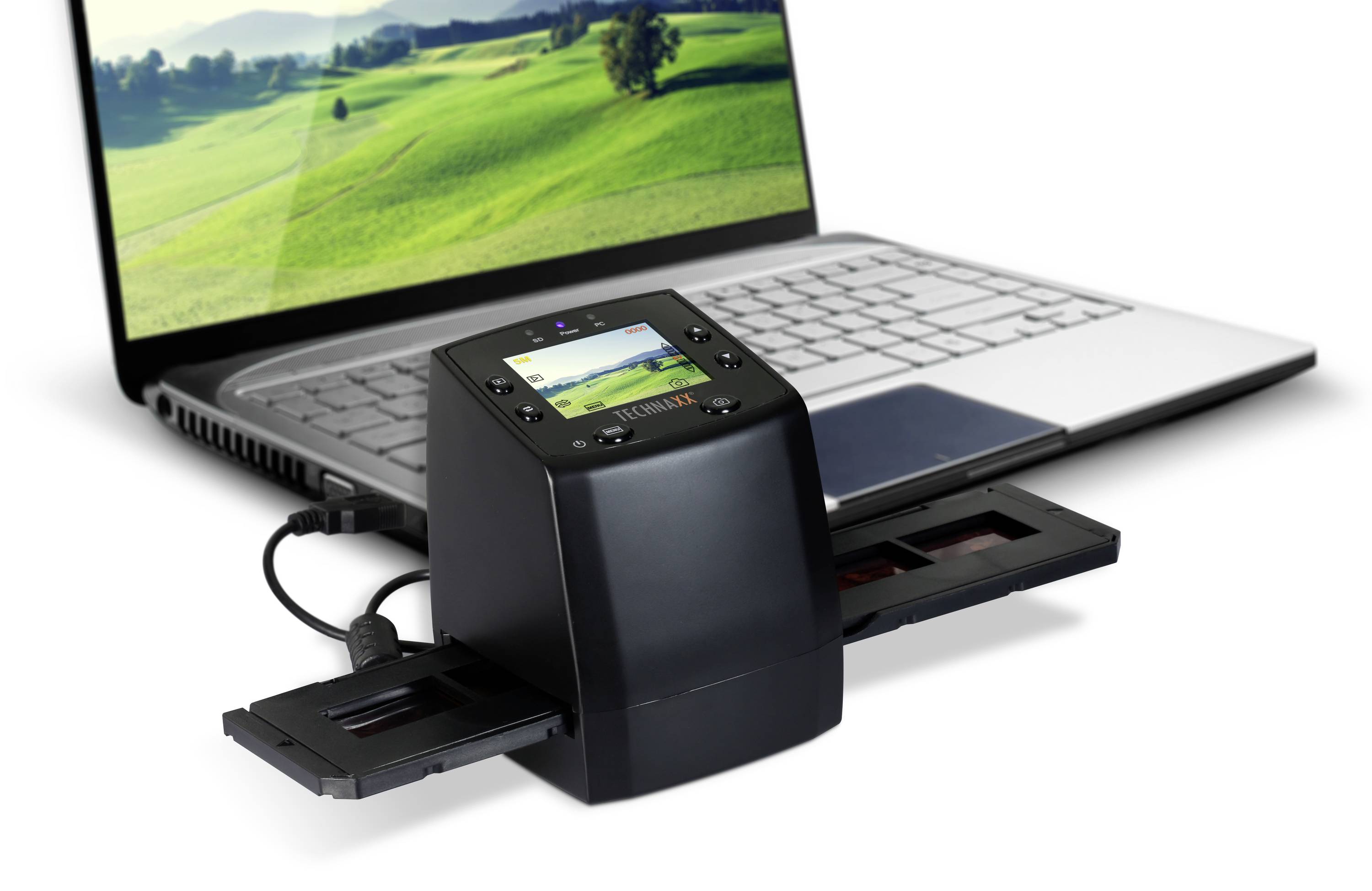 Een digitale scanner digitaliseert dia's op een laptop. Op de achtergrond is een monitor met een landschap te zien.