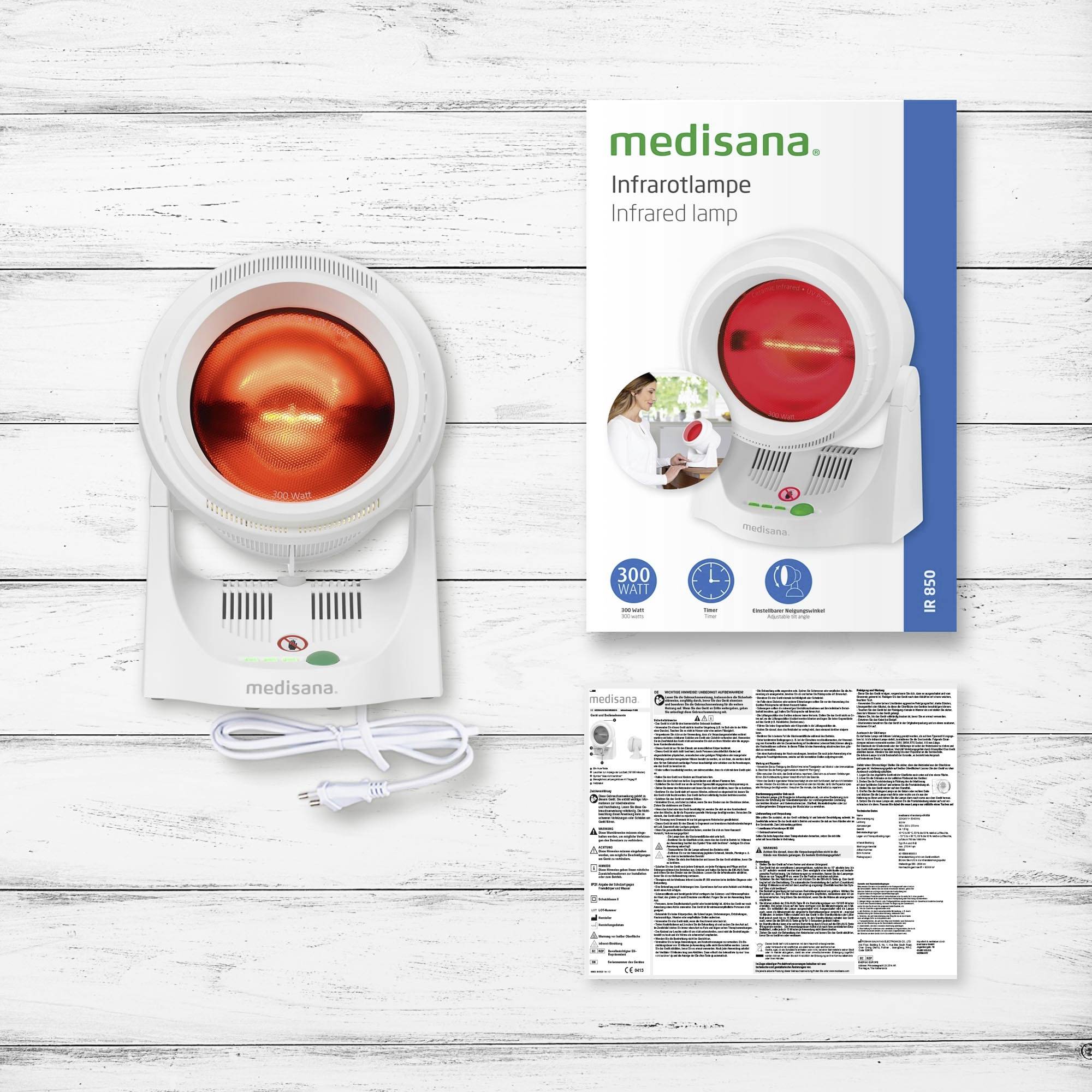 Infraroodlamp van Medisana met rood licht, geschikt voor warmtebehandelingen. Verpakking toont toepassingen. Bevat gebruiksaanwijzing.