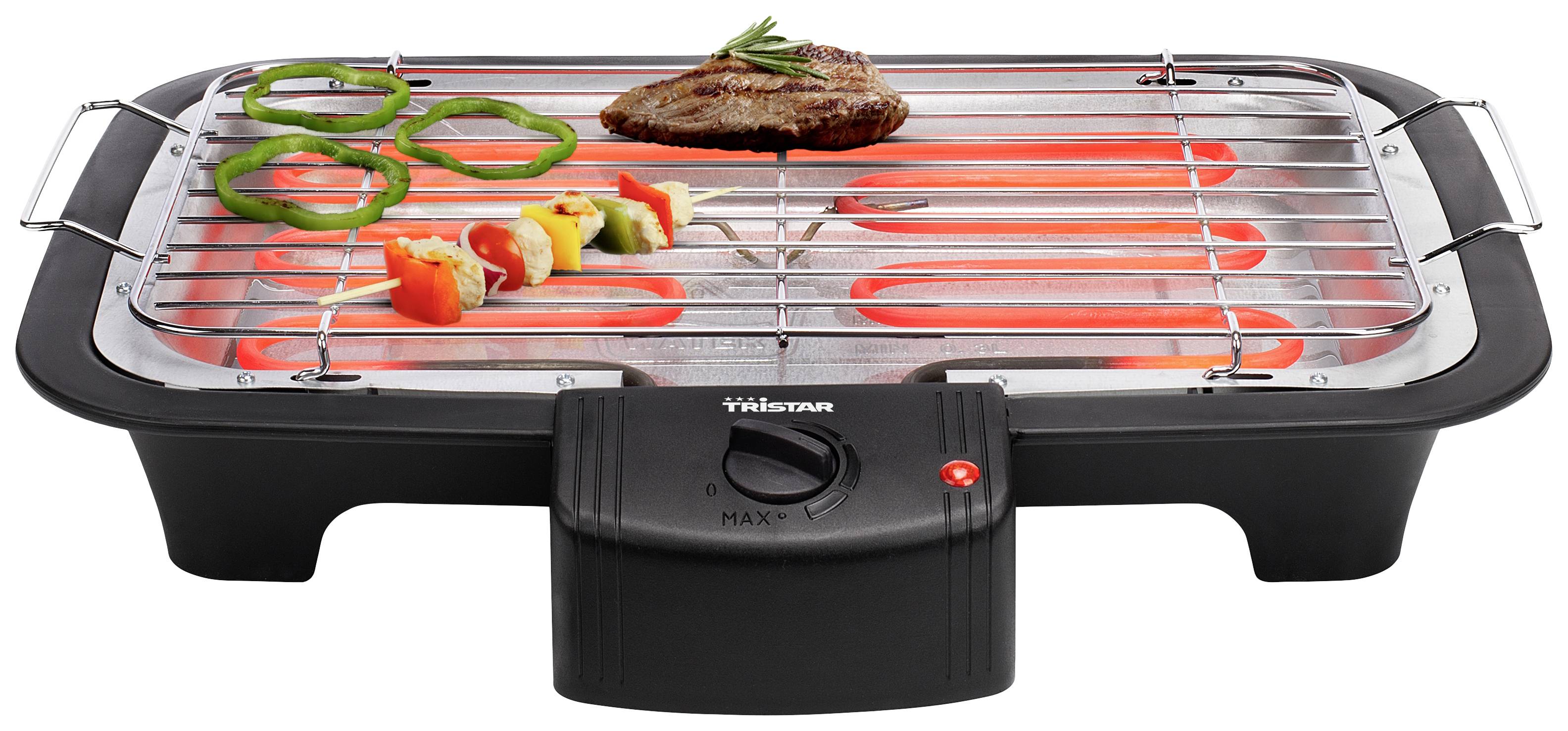 Elektrische tafelgrill met vlees, paprika en sjasliek aan het roosteren; rode verwarmingselementen zijn eronder zichtbaar.