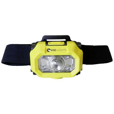 Gele hoofdlamp met zwart hoofdband. Op de lamp staat 'KSE-LIGHTS'. Hij heeft een grote lens en een rechthoekige vorm.