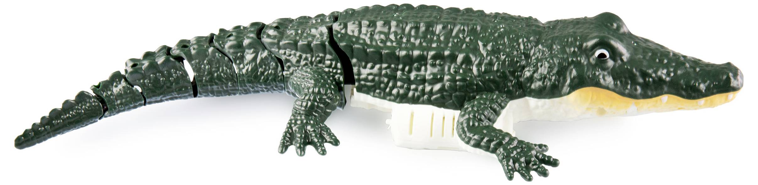 Groen plastic speelgoed in de vorm van een krokodil, liggend op een witte achtergrond.