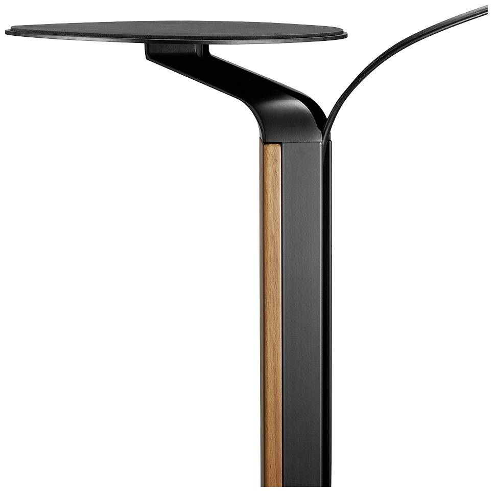 Moderne, minimalistische tafel in zwart en houtkleur. Elegant design met een slanke, ronde tafelblad.