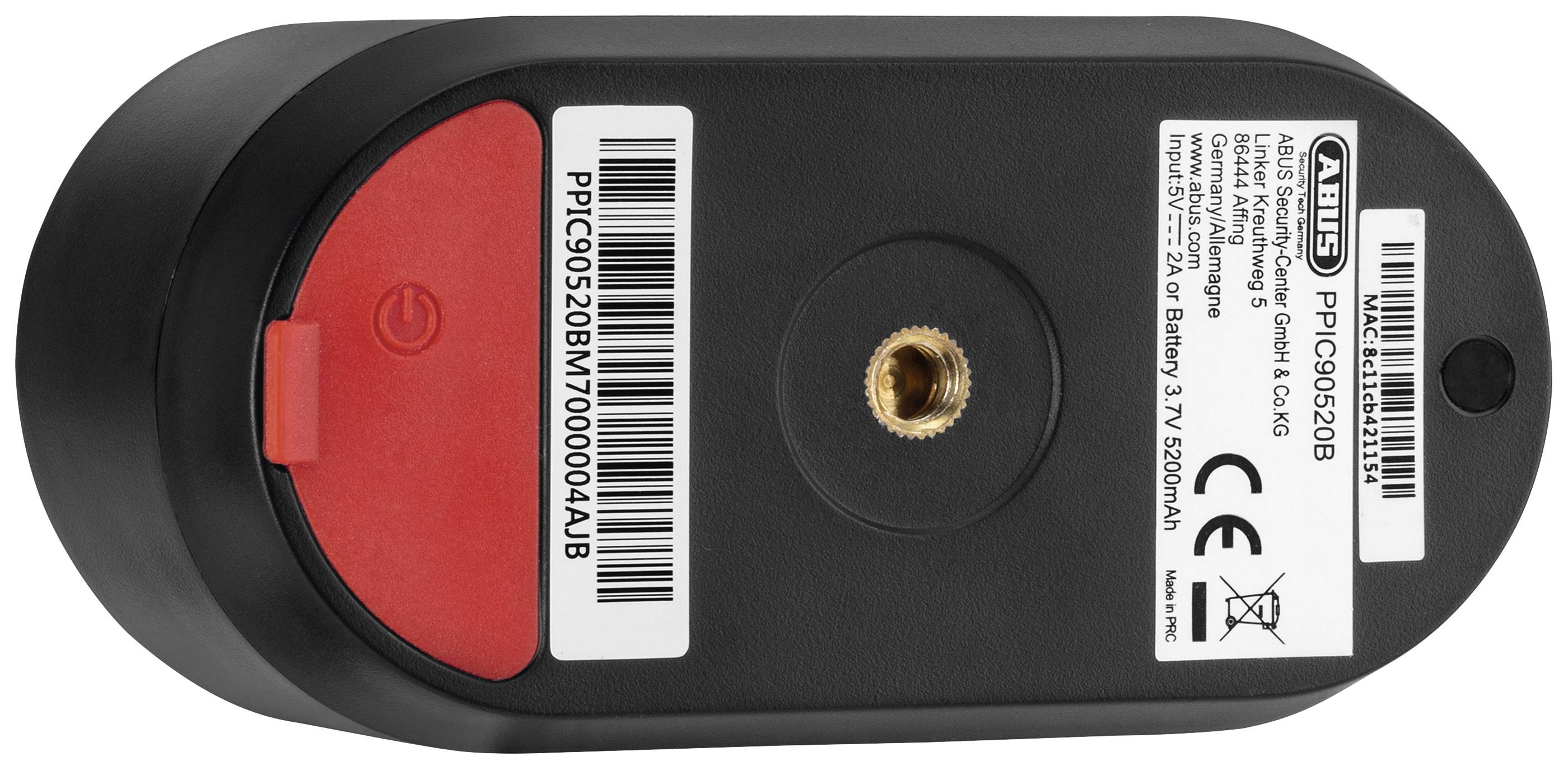 Onderkant van een zwart, rechthoekig elektronisch apparaat met rode en zwarte stickers en technische specificaties.